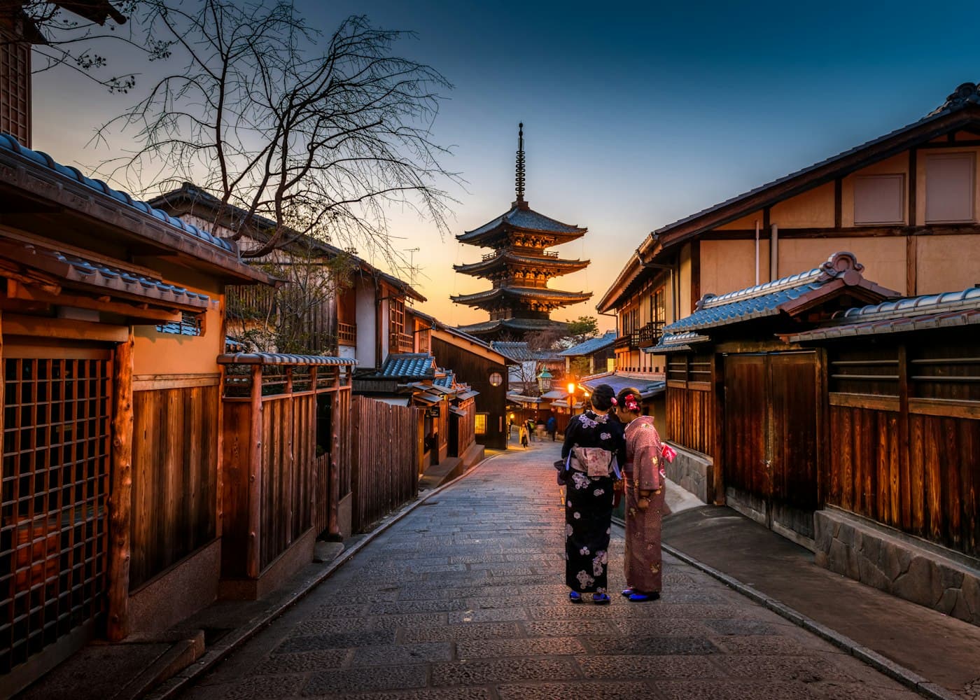 Travellers walking a historic street in Kyoto
